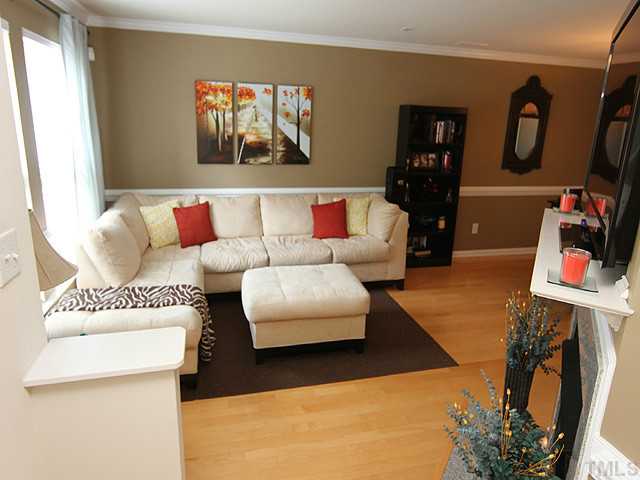 9712 Layla Avenue Raleigh, NC 27617 - Photo 5 of 25 a living room with furniture and a flat screen tv