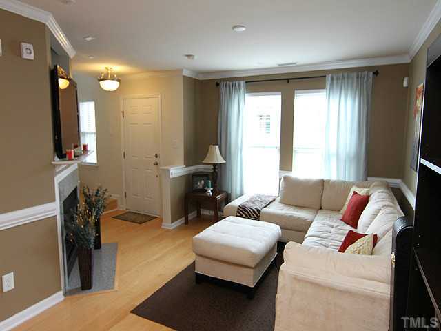 9712 Layla Avenue Raleigh, NC 27617 - Photo 7 of 25 a living room with furniture and a flat screen tv