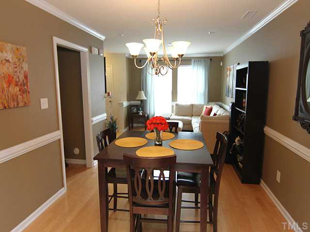 9712 Layla Avenue Raleigh, NC 27617 - Photo 9 of 25 a view of a dining room with furniture and a chandelier