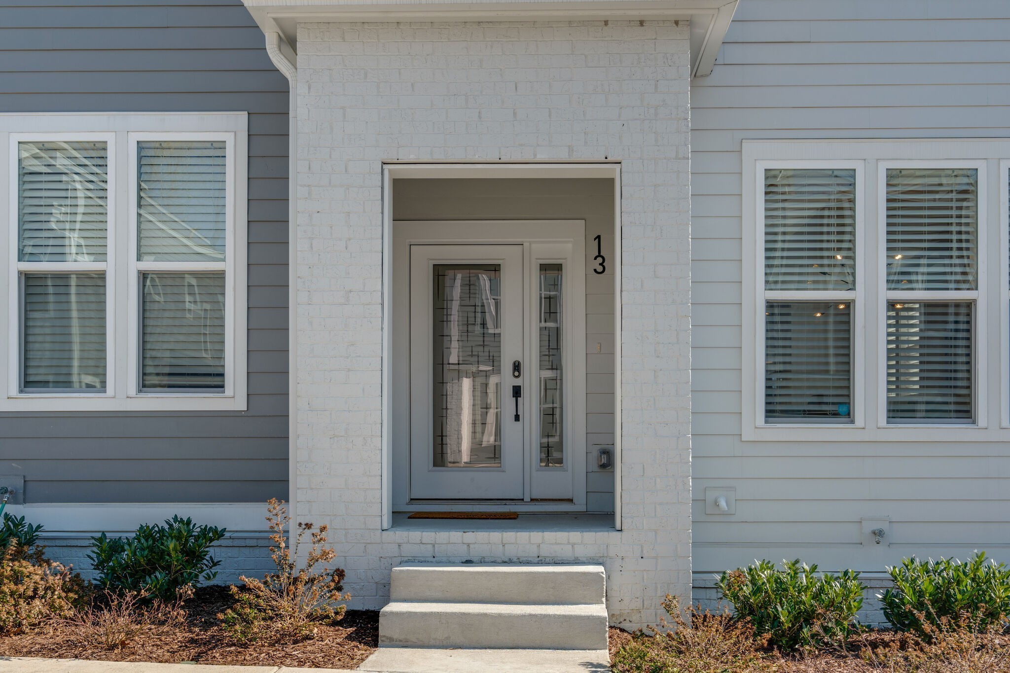 500 Creative Way, Unit 13 Madison, TN 37115 - Photo 4 of 33 a front view of a house with a potted plant windows