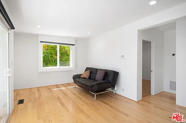 a living room with a furniture and a window