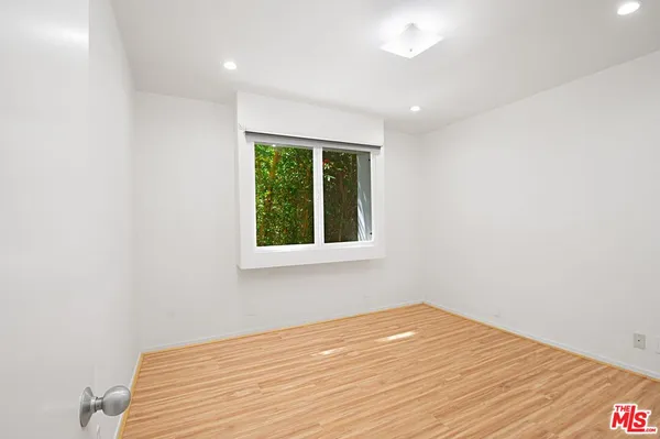 a view of a room with wooden floor and fan