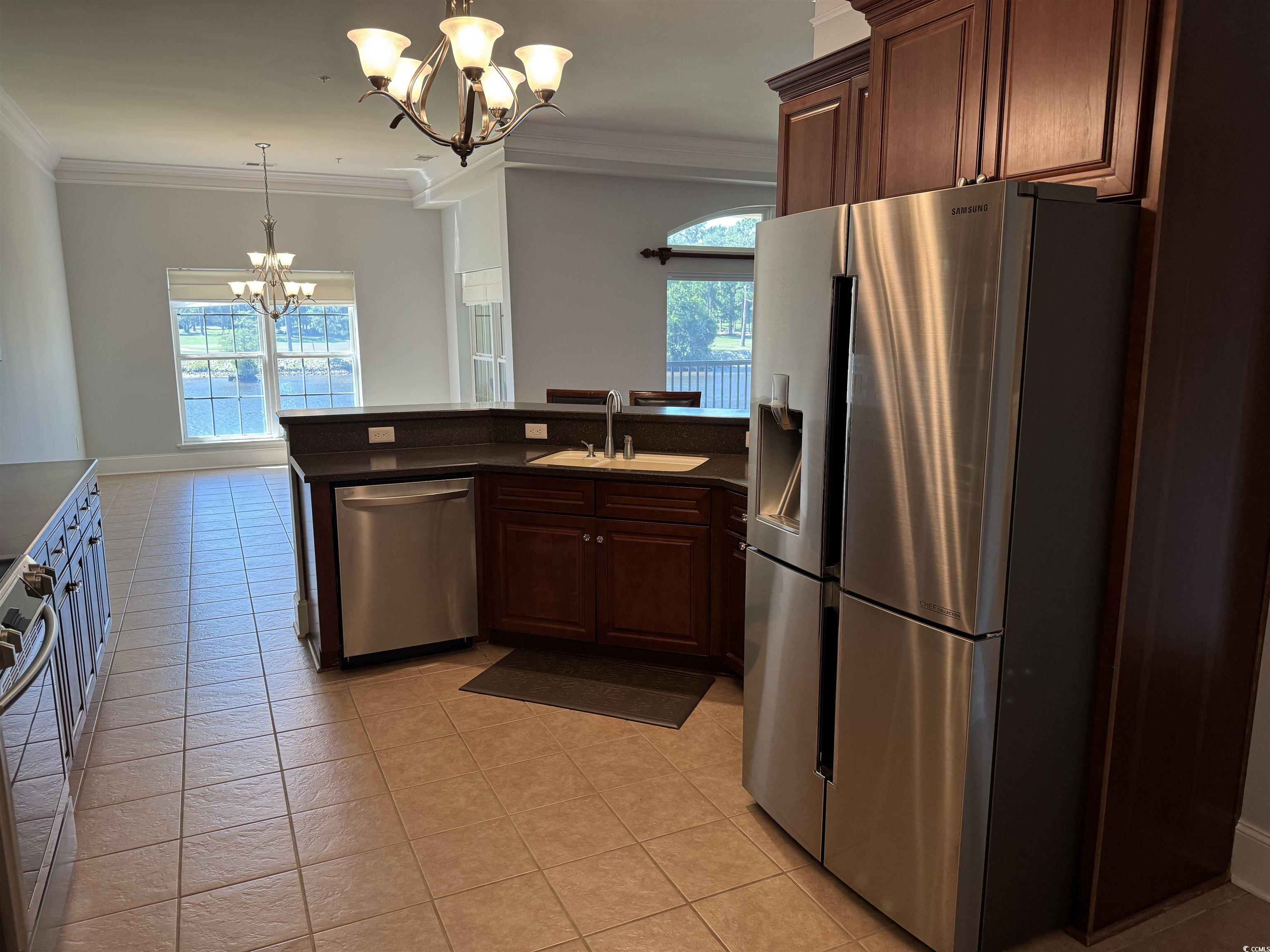 249 Venice Way, Unit 3105 Myrtle Beach, SC 29577 - Photo 11 of 40 Kitchen with appliances with stainless steel finishes, crown molding, sink, pendant lighting, and a chandelier