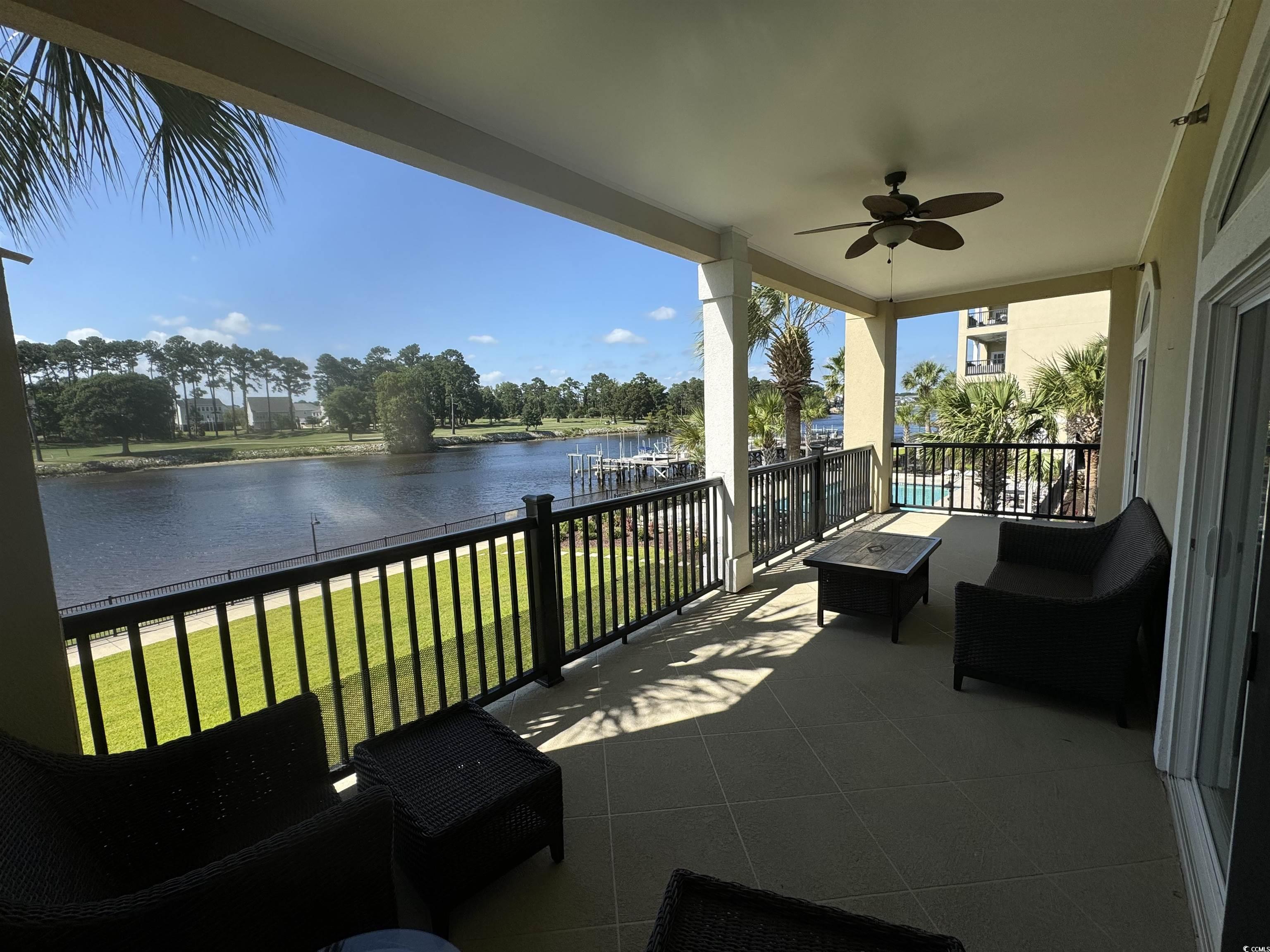 249 Venice Way, Unit 3105 Myrtle Beach, SC 29577 - Photo 2 of 40 View of patio featuring ceiling fan, a balcony, and a water view