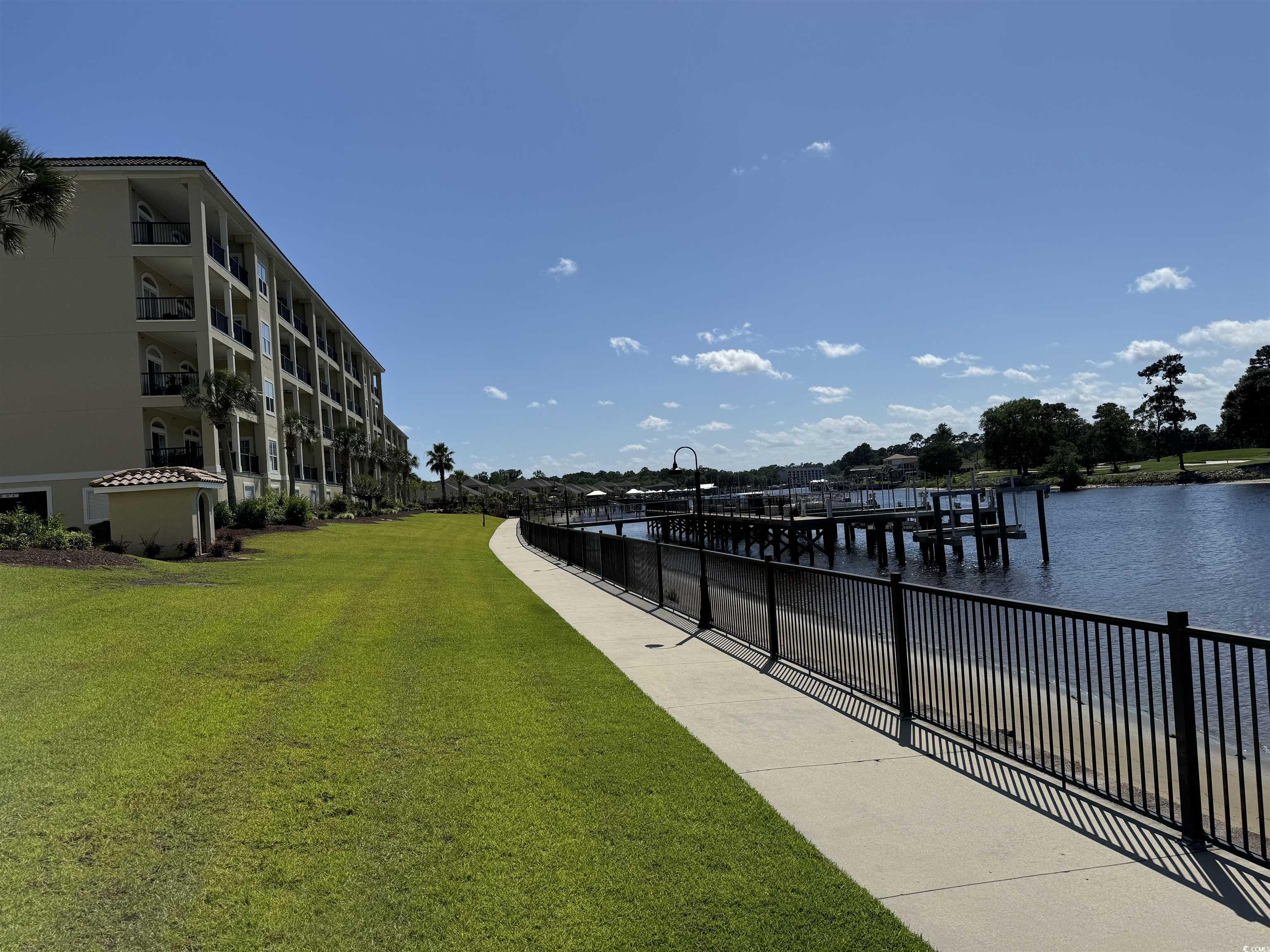 249 Venice Way, Unit 3105 Myrtle Beach, SC 29577 - Photo 27 of 40 Dock area featuring a lawn and a water view