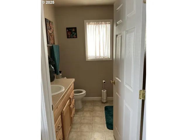 a bathroom with a toilet a sink and a mirror