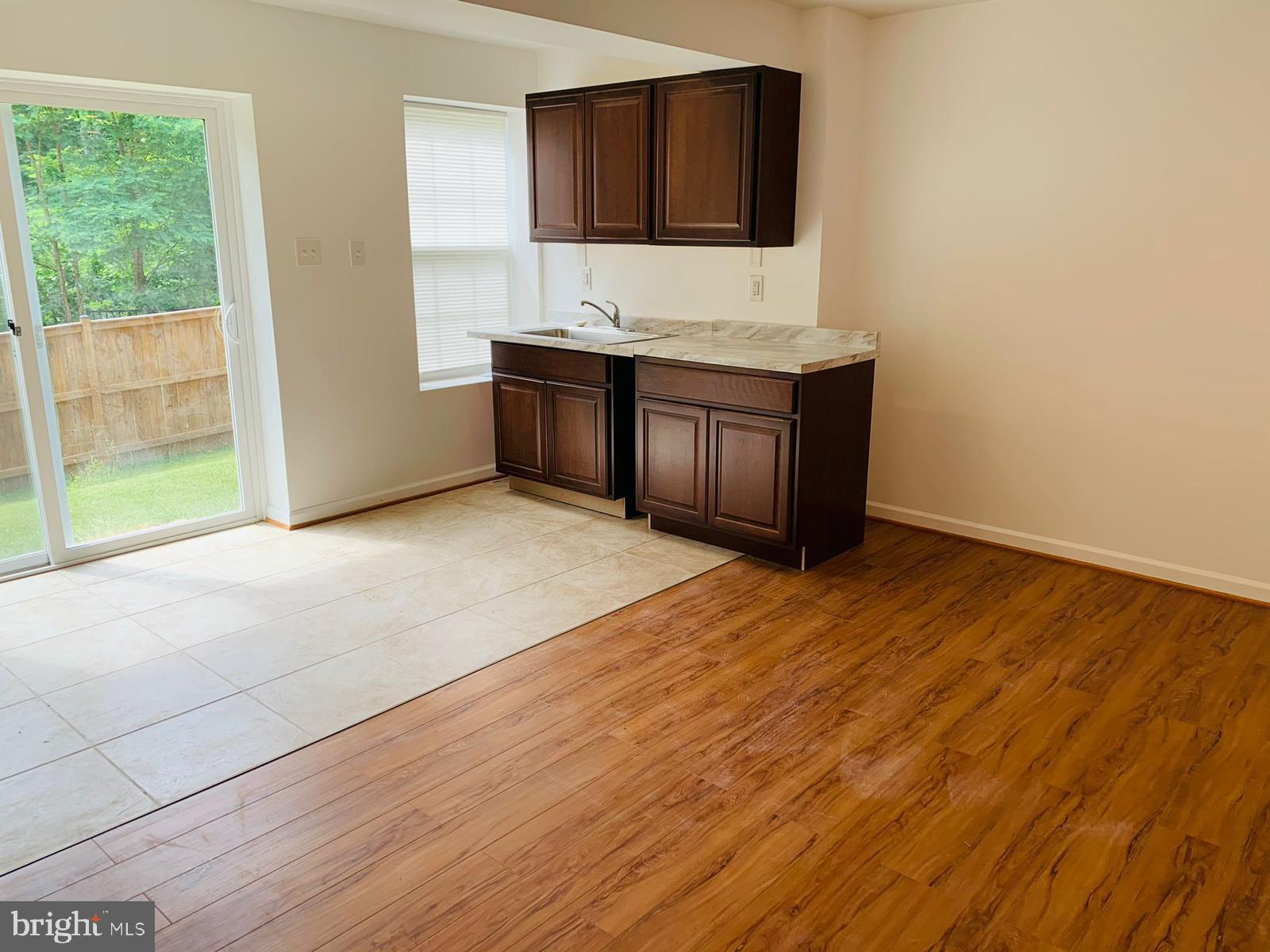a room with wooden cabinets and sink