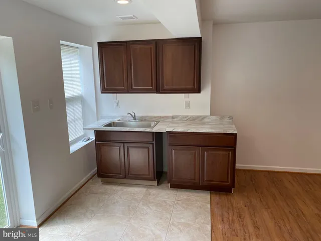 a kitchen with a sink and a stove top oven