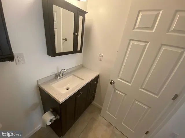 a bathroom with a sink toilet and mirror