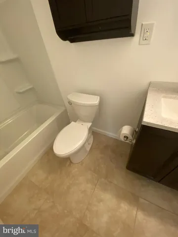 a bathroom with a toilet and a bathtub