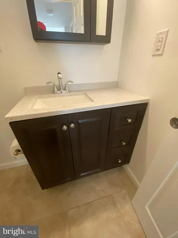 a bathroom with a sink vanity and mirror