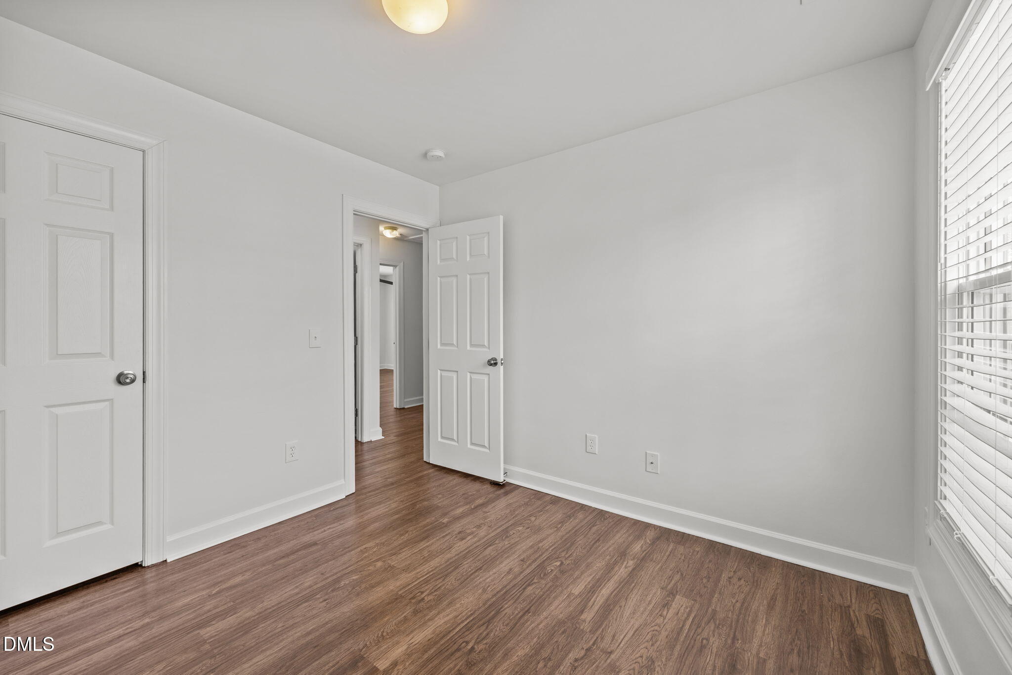 9220 Pennythorne Court Raleigh, NC 27615 - Photo 25 of 49 an empty room with wooden floor and windows
