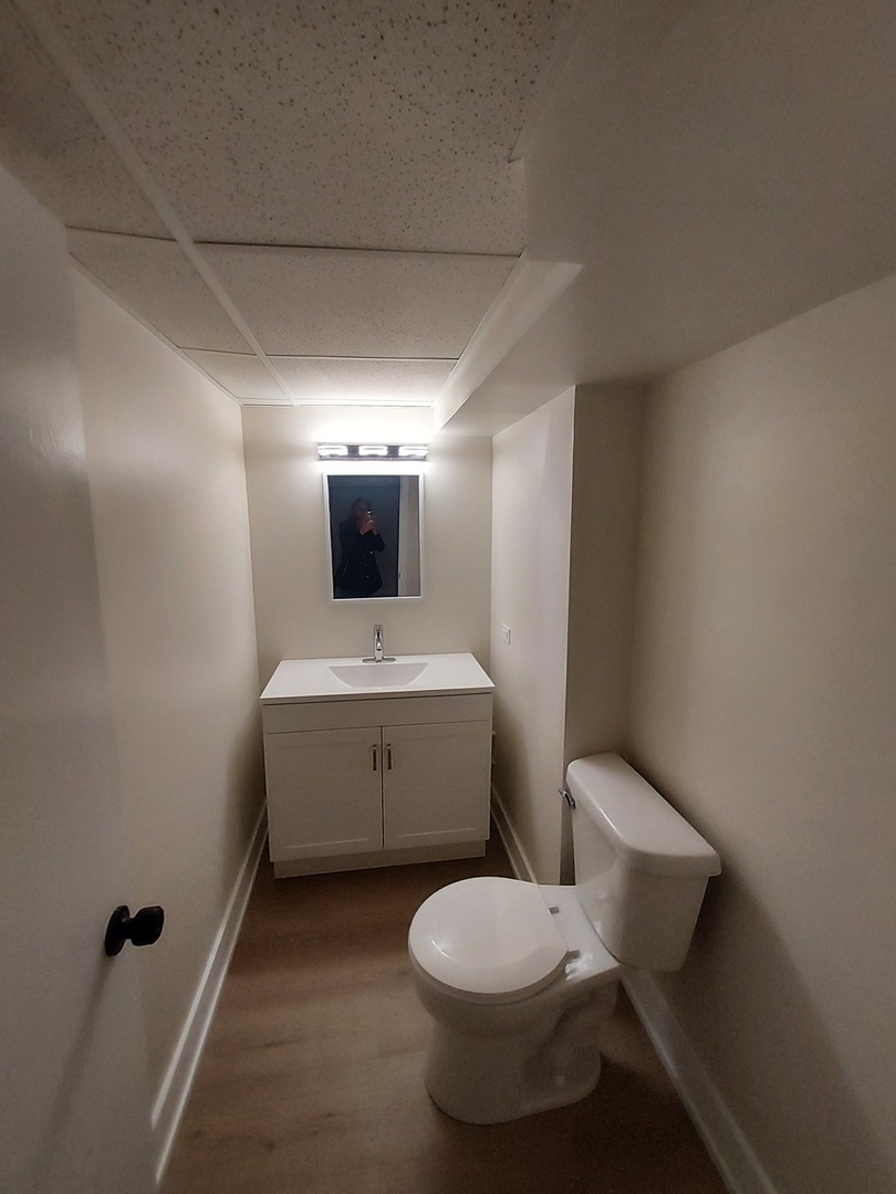 1001 North Dee Road, Unit A Park Ridge, IL 60068 - Photo 11 of 13 a bathroom with a toilet sink and mirror