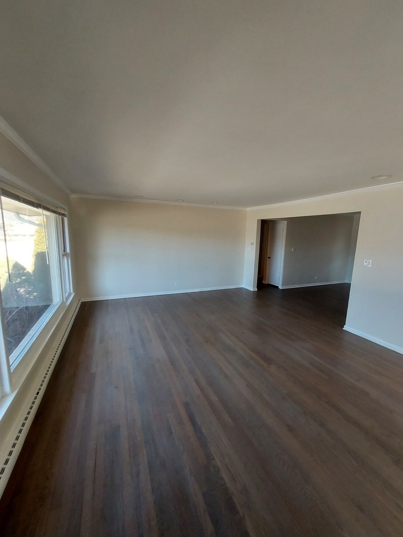 1001 North Dee Road, Unit A Park Ridge, IL 60068 - Photo 5 of 13 a view of empty room with wooden floor and fan