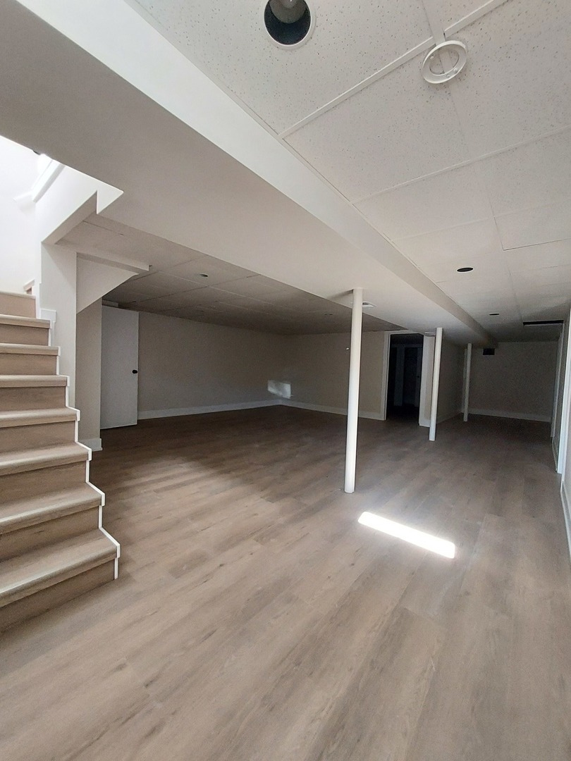 1001 North Dee Road, Unit A Park Ridge, IL 60068 - Photo 6 of 13 a view of an empty room with stairs and furniture