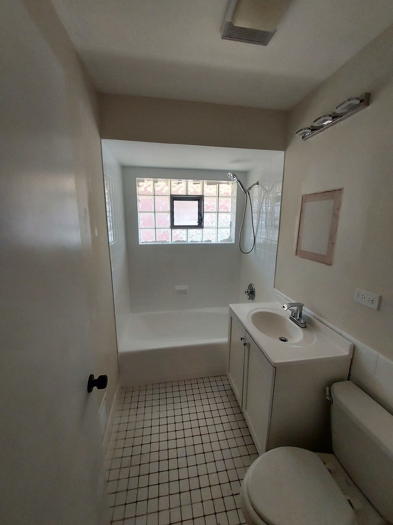 1001 North Dee Road, Unit A Park Ridge, IL 60068 - Photo 10 of 13 a bathroom with a sink a toilet and window