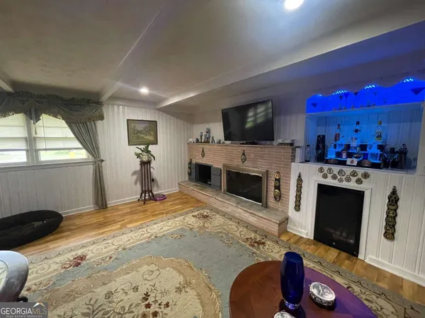 a bed room with a fireplace television and a window