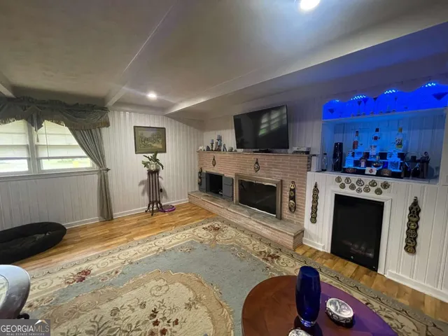 a bed room with a fireplace television and a window