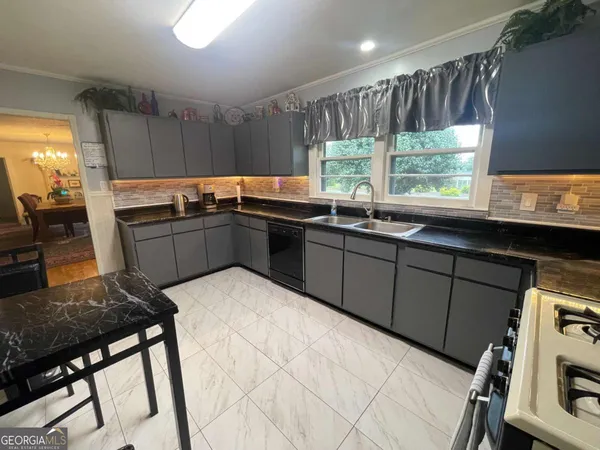 a kitchen with sink cabinets and wooden floor