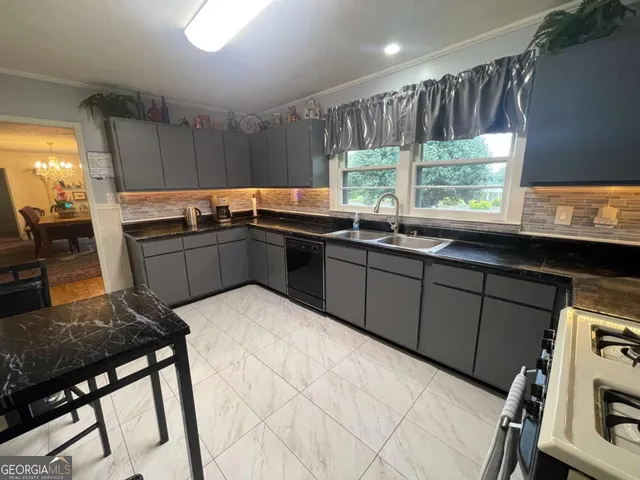 a kitchen with sink cabinets and wooden floor