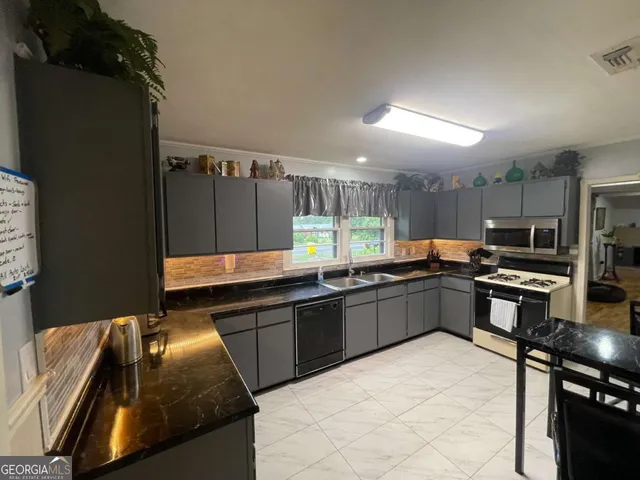 a kitchen with lots of counter top space and appliances