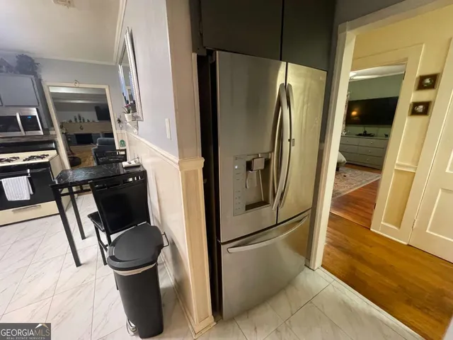 a view of a dining room with furniture and chandelier