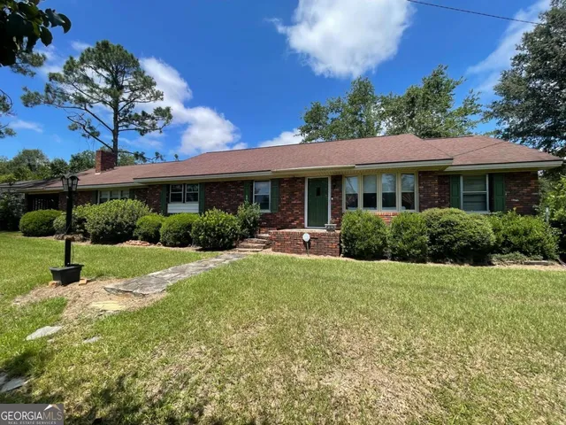 a view of a house with backyard and garden