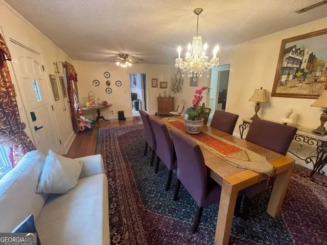 a bedroom with a bed and a lamp on dresser