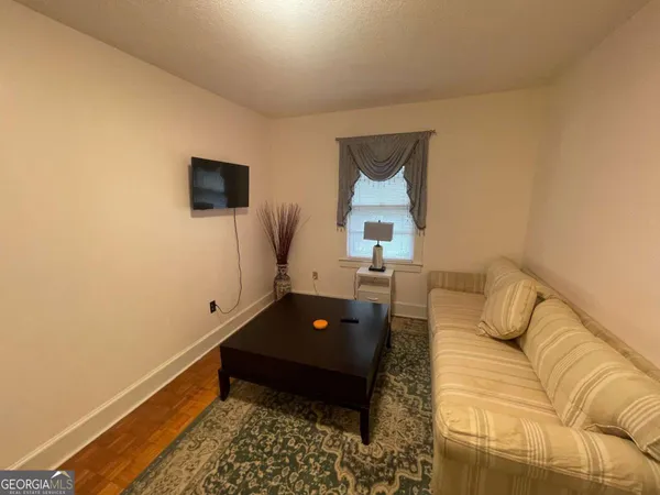 a utility room with dryer washer and a view of living room