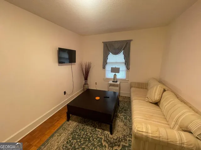 a utility room with dryer washer and a view of living room