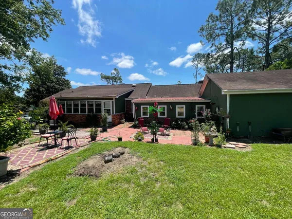 a view of a house with a yard porch and sitting area