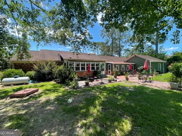 a front view of house with yard and outdoor seating
