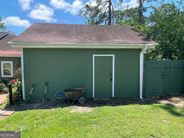 a backyard of a house with table and chairs