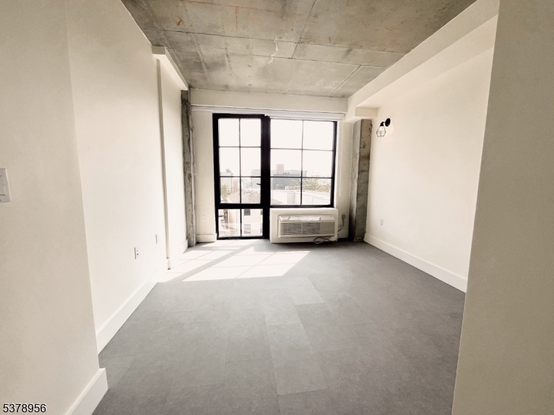 59 McWhorter Street, Unit 405 Newark, NJ 07105 - Photo 4 of 9 an empty room with windows
