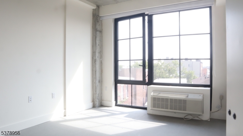 59 McWhorter Street, Unit 405 Newark, NJ 07105 - Photo 5 of 9 a bedroom with a bed and a window