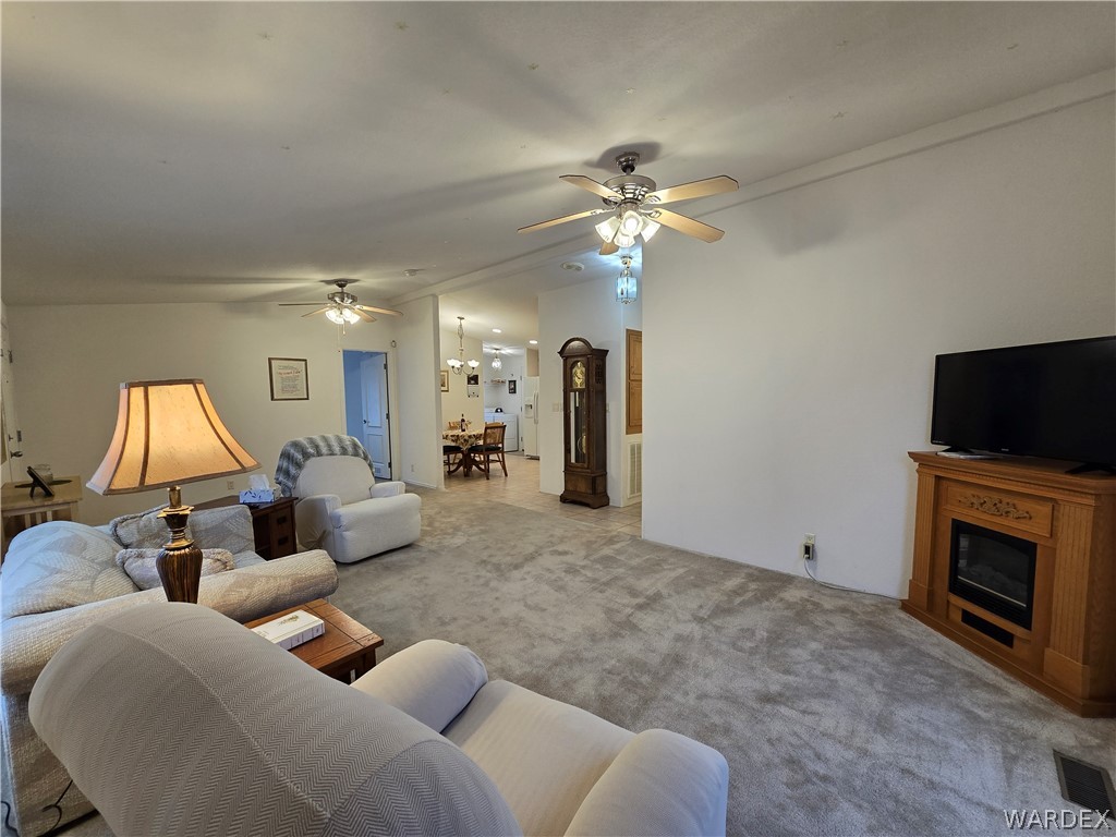 4950-17 Apache Road Golden Valley, AZ 86413 - Photo 20 of 100 a living room with furniture a fireplace and a flat screen tv
