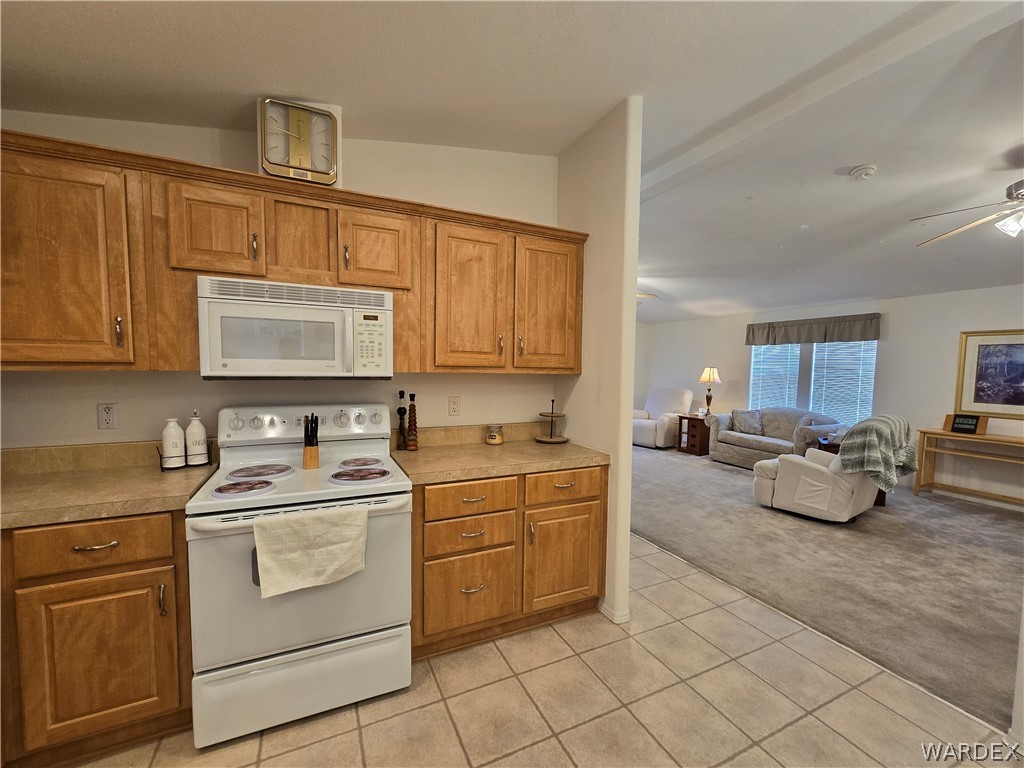 4950-17 Apache Road Golden Valley, AZ 86413 - Photo 31 of 100 a kitchen with a stove a sink and a microwave