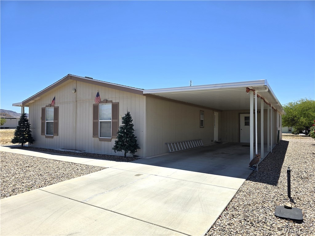 4950-17 Apache Road Golden Valley, AZ 86413 - Photo 5 of 100 a front view of a house with a outdoor space