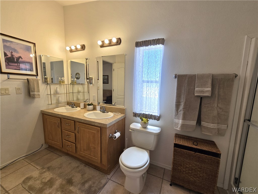 4950-17 Apache Road Golden Valley, AZ 86413 - Photo 54 of 100 a bathroom with a sink toilet and shower