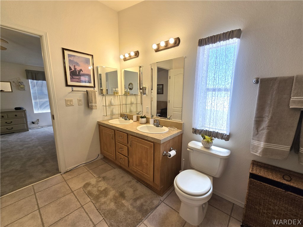 4950-17 Apache Road Golden Valley, AZ 86413 - Photo 56 of 100 a bathroom with a toilet sink and mirror