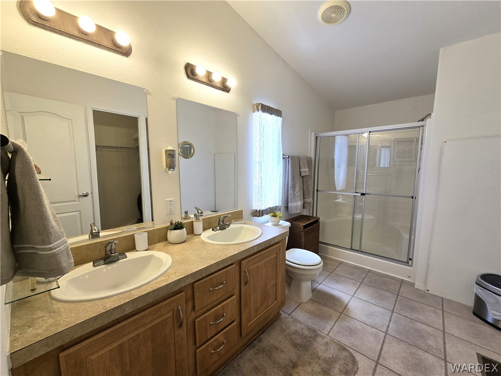 4950-17 Apache Road Golden Valley, AZ 86413 - Photo 60 of 100 a bathroom with a double vanity sink toilet and a mirror