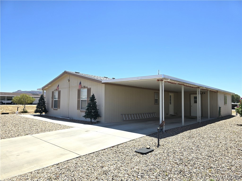 4950-17 Apache Road Golden Valley, AZ 86413 - Photo 6 of 100 a front view of a house with a garage