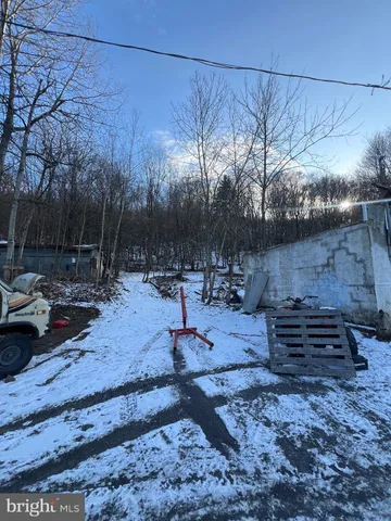 a view of a backyard with sitting area