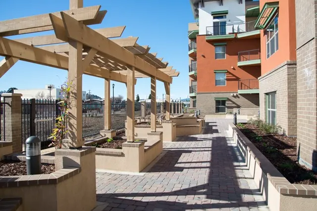 a view of a patio with couches chairs and wooden floor