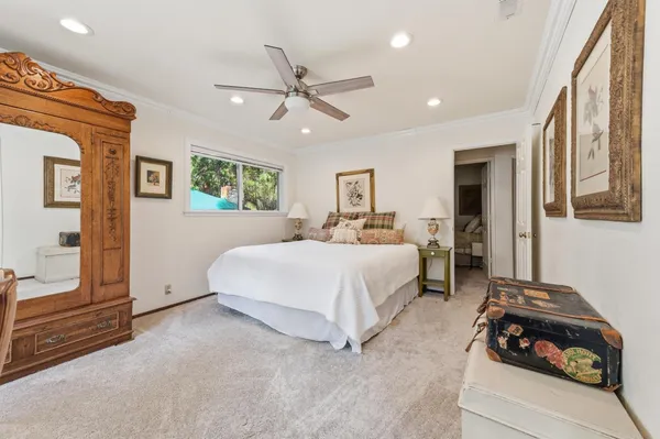 a bedroom with a bed and a large mirror