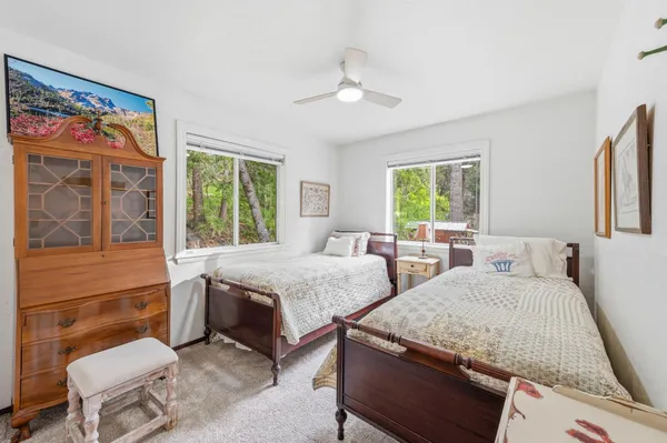 a bedroom with two beds and a large window