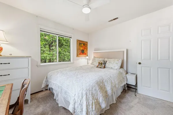 a bedroom with a bed lamp and a window