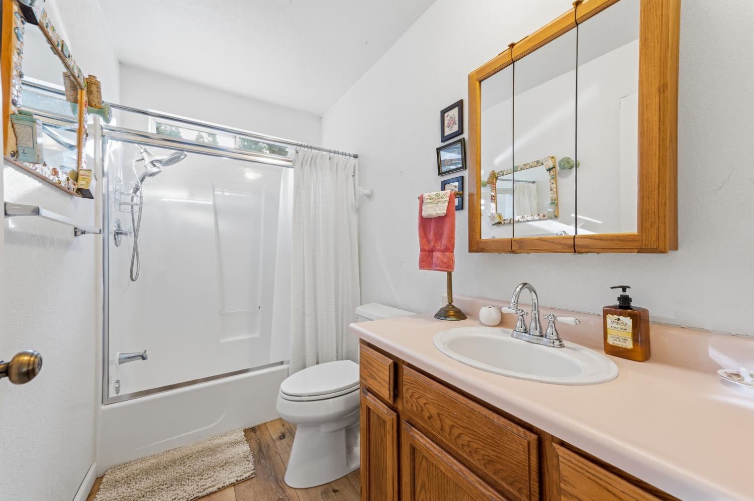 21 Spring Street Sierra City, CA 96125 - Photo 18 of 30 a bathroom with a granite countertop sink mirror vanity and toilet