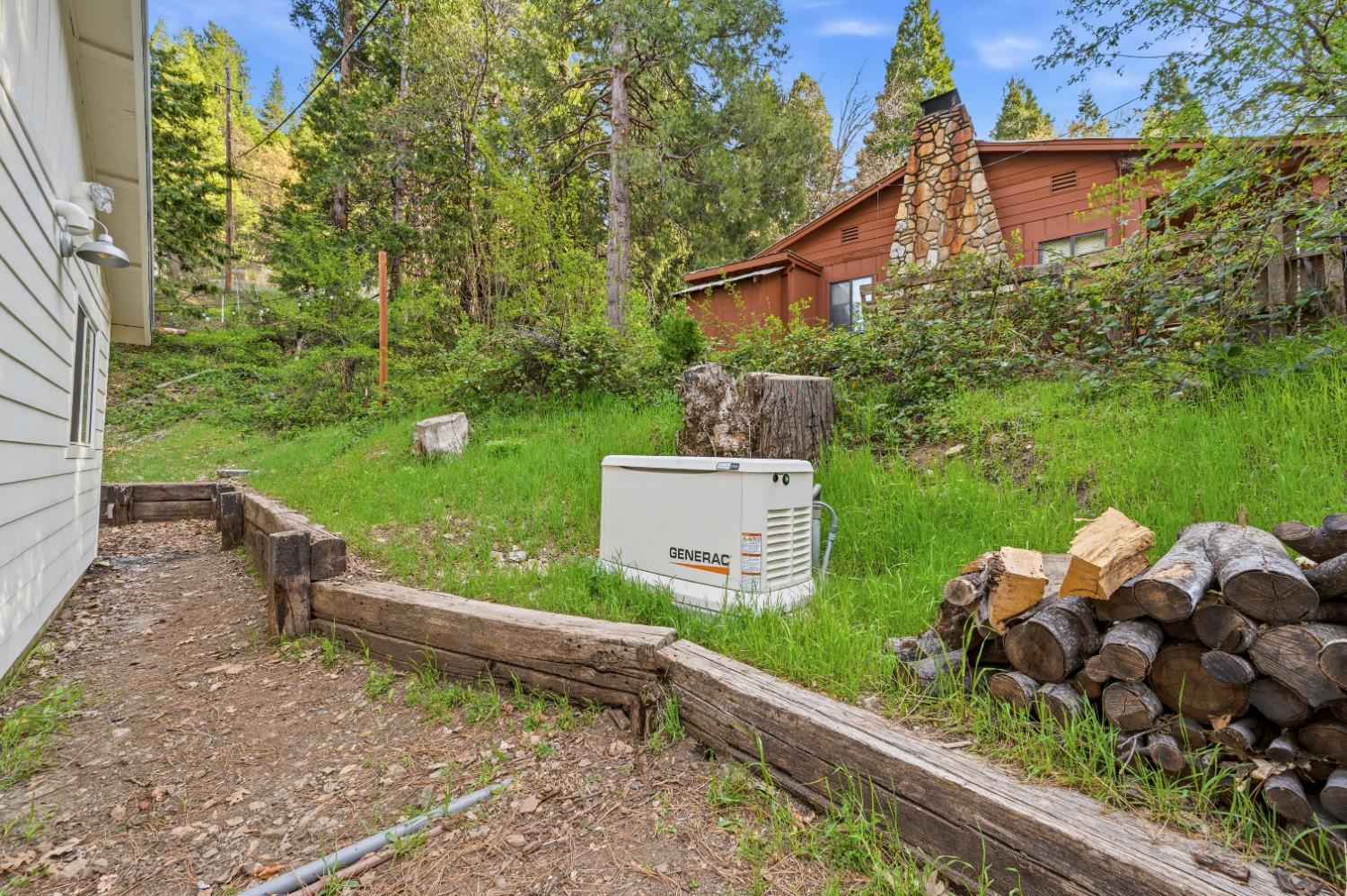 21 Spring Street Sierra City, CA 96125 - Photo 22 of 30 a backyard of a house with a garden and outdoor seating