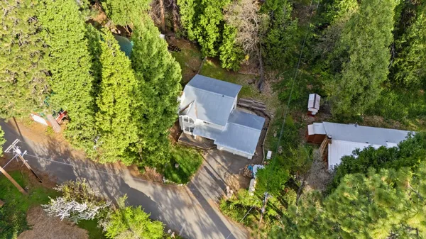 an aerial view of a house with a yard and garden